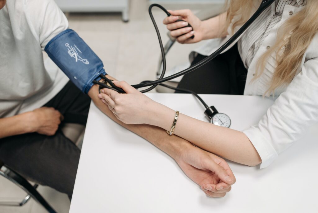 physician associate taking blood pressure on a patient